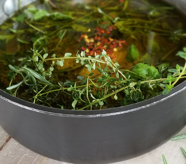 herbs and oil in pot
