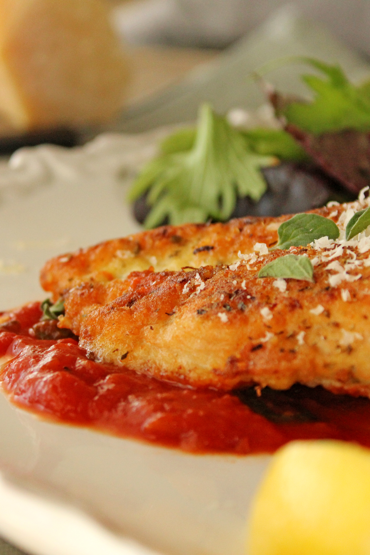 parmesan chicken on plate with parm cheese