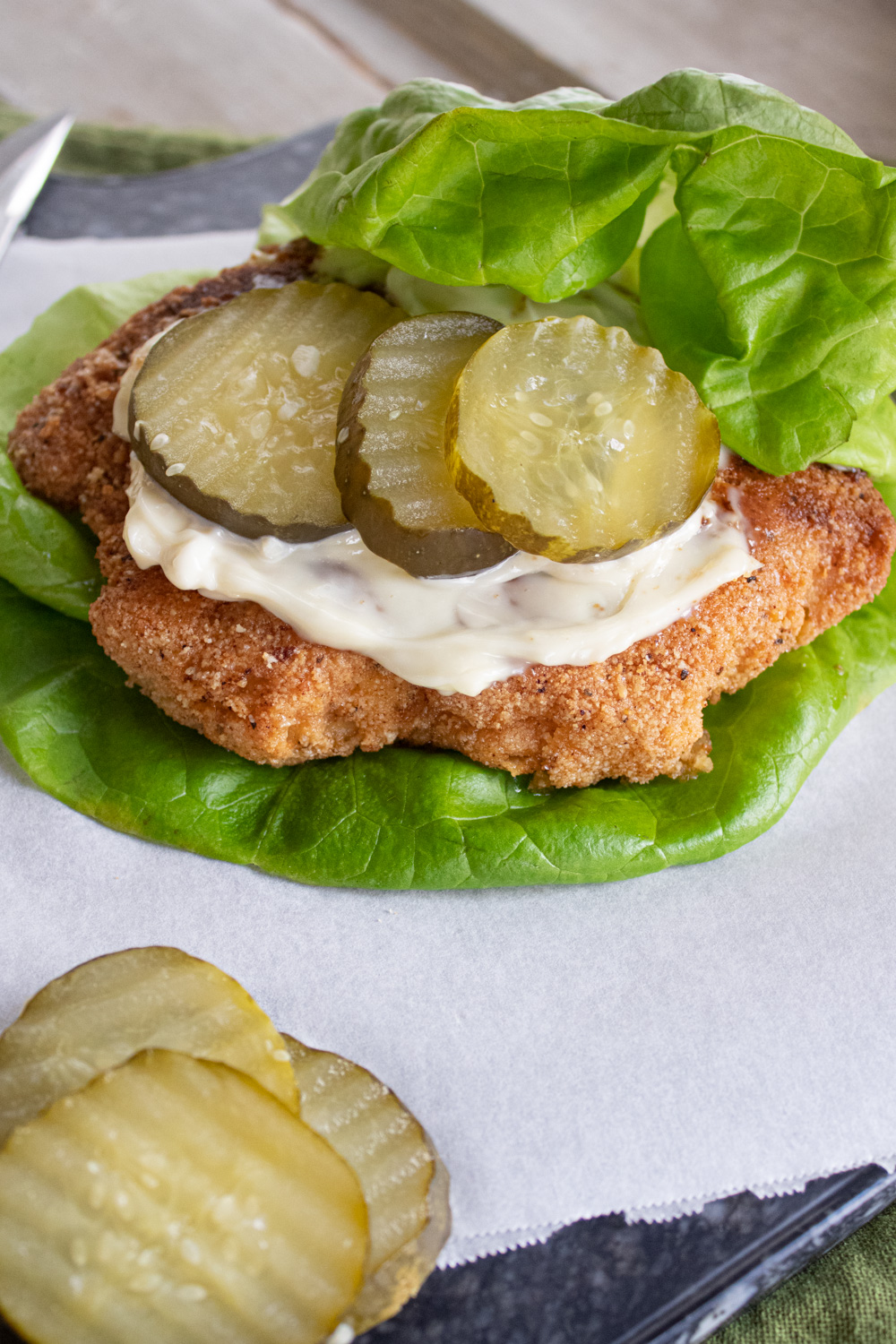 Chick-fil-a sandwich on lettuce with pickles