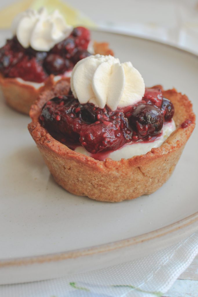 close angle of cheesecake cup with mixed fruit jam