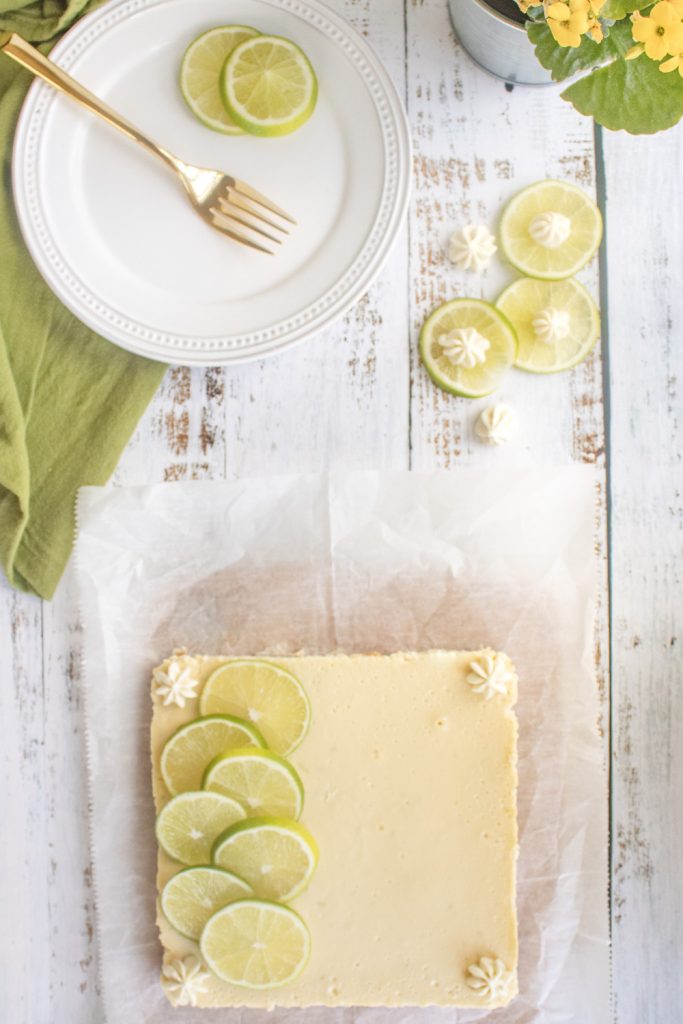 overhead of key lime cheesecake bars and plate