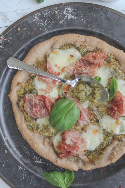 healthy homemade pizza with spoon of leek confit
